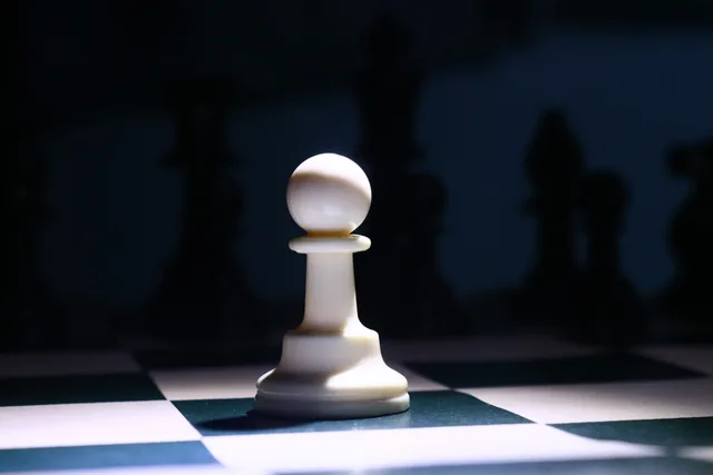 Close-up of a white chess pawn highlighted dramatically on a chessboard, depicting strategy and focus. Ecommerce platform governance